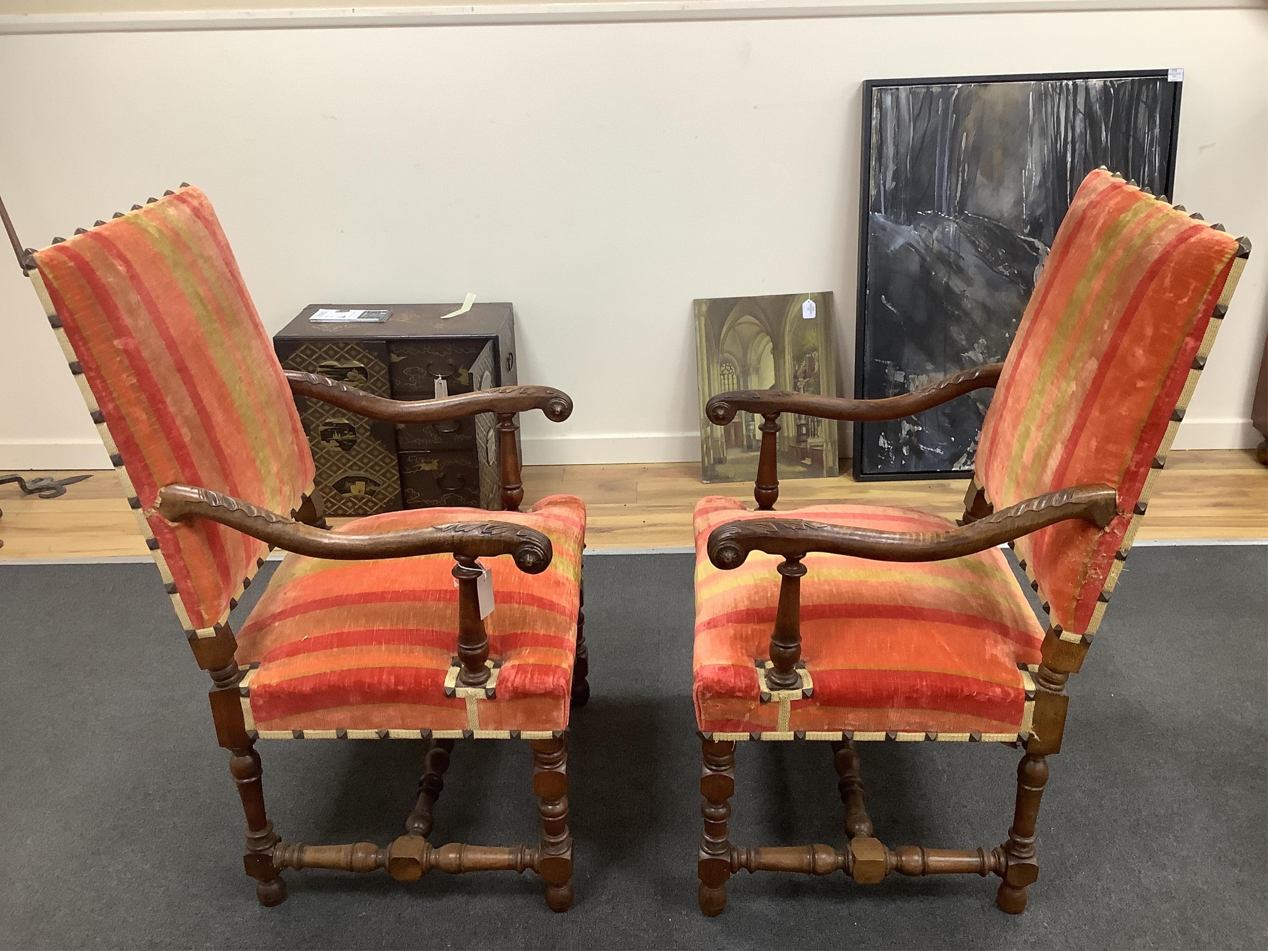 A pair of French walnut elbow chairs, width 65cm, depth 55cm, height 110cm. Condition - fair